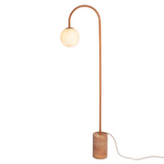 My Store 5 Tivoli floor lamp in terra with a travertine base and a spherical glass shade on a curved metal stand.